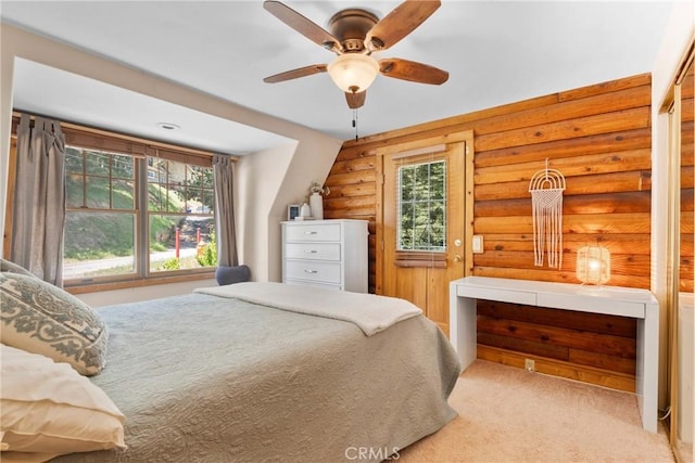 379 Dorn Dr, Crestline, CA 92325 - carpeted bedroom featuring rustic walls, multiple windows, and a ceiling fan
