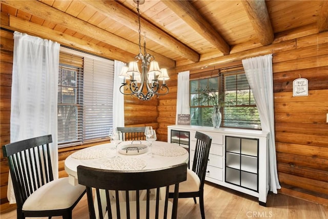 379 Dorn Dr, Crestline, CA 92325 - dining area featuring rustic walls, a chandelier, wood ceiling with exposed beams, and light wood-style flooring