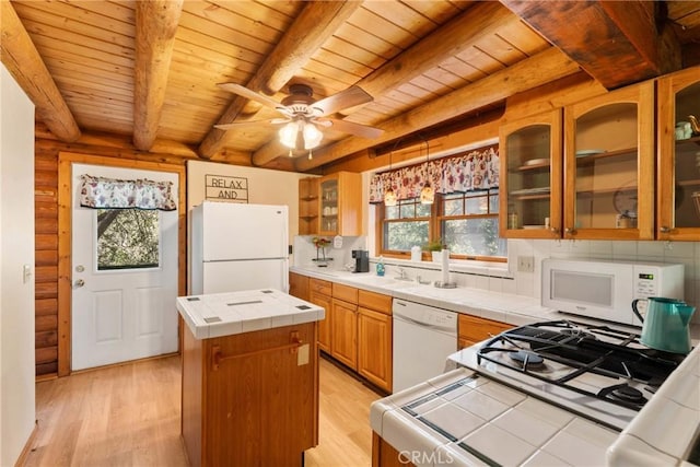379 Dorn Dr, Crestline, CA 92325 - kitchen with white appliances, tile countertops, wooden ceiling with exposed beams, a center island, and light wood finished floors