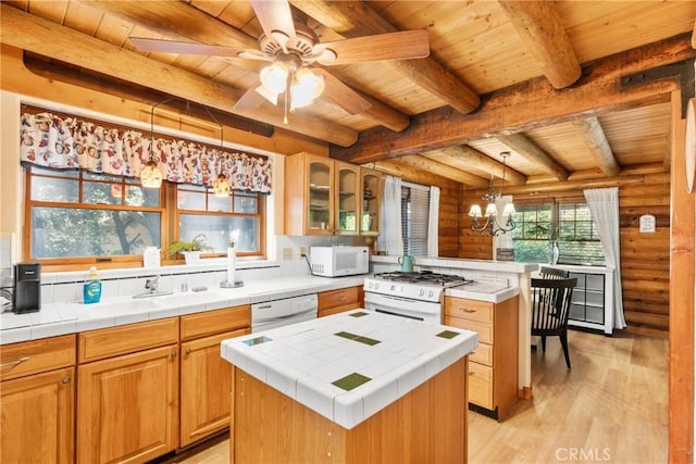 379 Dorn Dr, Crestline, CA 92325 - kitchen featuring white appliances, wood ceiling with exposed beams, log walls, tile counters, and light wood-style flooring