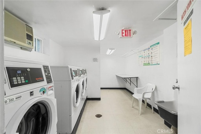 3603 W Hidden Ln Unit 317, Rolling Hills Estates, CA 90274 - shared laundry featuring independent washer and dryer, an AC wall unit, and baseboards