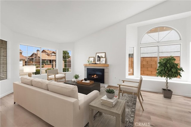 37109 Daisy St, Palmdale, CA 93550 - living room featuring light wood-style floors, a brick fireplace, and baseboards