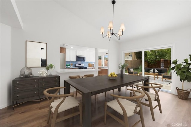 37109 Daisy St, Palmdale, CA 93550 - dining room featuring light wood-style flooring, a chandelier, and a towering ceiling