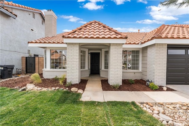 37109 Daisy St, Palmdale, CA 93550 - view of front of house with brick siding, a tiled roof, and a garage
