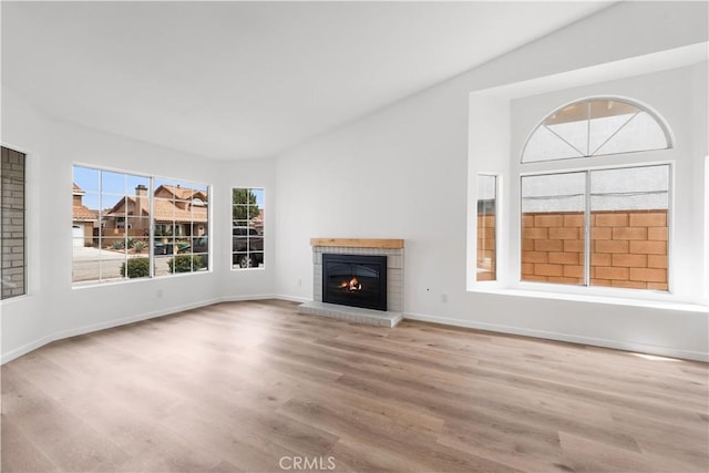 37109 Daisy St, Palmdale, CA 93550 - unfurnished living room with a fireplace, wood finished floors, lofted ceiling, and baseboards