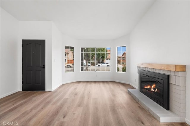 37109 Daisy St, Palmdale, CA 93550 - unfurnished living room featuring light wood finished floors, a brick fireplace, and baseboards