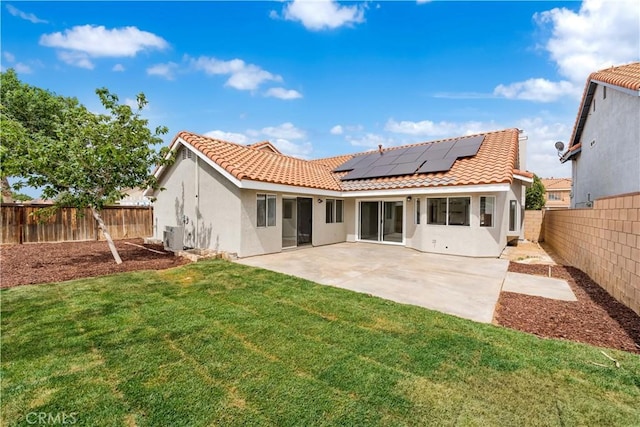 37109 Daisy St, Palmdale, CA 93550 - back of property featuring stucco siding, roof mounted solar panels, a tile roof, a patio, and ac unit