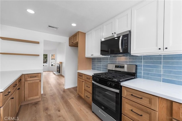 37109 Daisy St, Palmdale, CA 93550 - kitchen with appliances with stainless steel finishes, open shelves, light countertops, backsplash, and recessed lighting