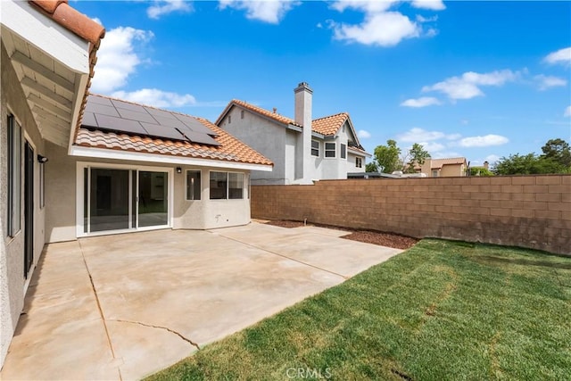 37109 Daisy St, Palmdale, CA 93550 - rear view of house featuring stucco siding, a tile roof, solar panels, and a patio area