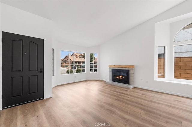 37109 Daisy St, Palmdale, CA 93550 - unfurnished living room featuring light wood finished floors, a brick fireplace, and baseboards