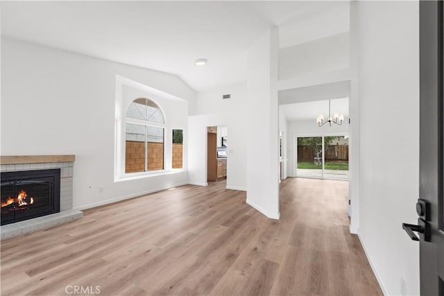 37109 Daisy St, Palmdale, CA 93550 - unfurnished living room with a fireplace, healthy amount of natural light, a chandelier, wood finished floors, and high vaulted ceiling