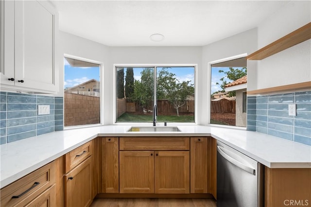 37109 Daisy St, Palmdale, CA 93550 - kitchen featuring stainless steel dishwasher, open shelves, a sink, and tasteful backsplash