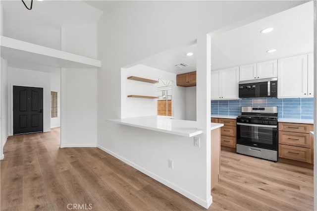37109 Daisy St, Palmdale, CA 93550 - kitchen with appliances with stainless steel finishes, light countertops, light wood-style floors, decorative backsplash, and recessed lighting