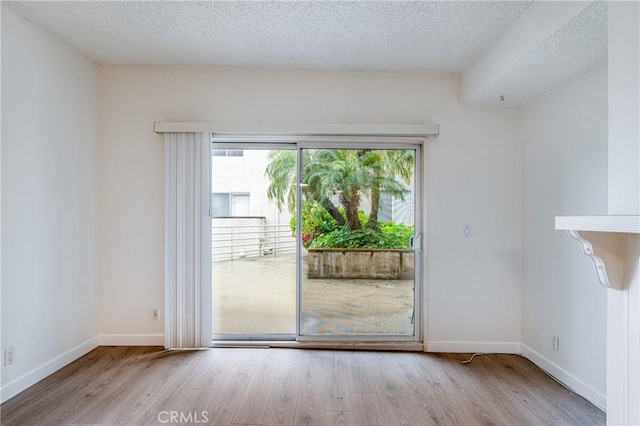 2905 Montrose Ave Unit 318, La Crescenta, CA 91214 - spare room featuring a textured ceiling, wood finished floors, and baseboards