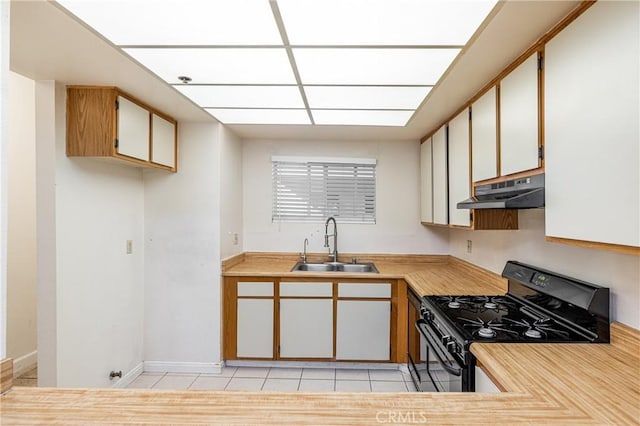2905 Montrose Ave Unit 318, La Crescenta, CA 91214 - kitchen featuring gas stove, under cabinet range hood, a sink, light countertops, and light tile patterned floors