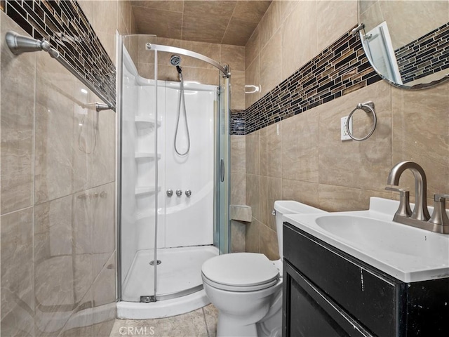 38809 Juniper Tree Rd, Palmdale, CA 93551 - bathroom featuring a stall shower, tile walls, toilet, vanity, and tile patterned flooring