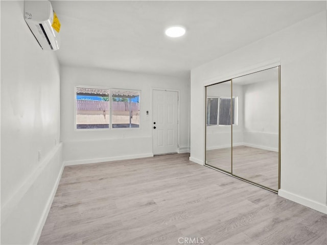 38809 Juniper Tree Rd, Palmdale, CA 93551 - entrance foyer with a wall mounted air conditioner, wood finished floors, and baseboards