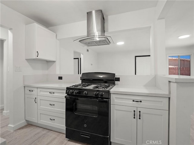 38809 Juniper Tree Rd, Palmdale, CA 93551 - kitchen featuring black range with gas stovetop, island range hood, light countertops, and light wood-style flooring
