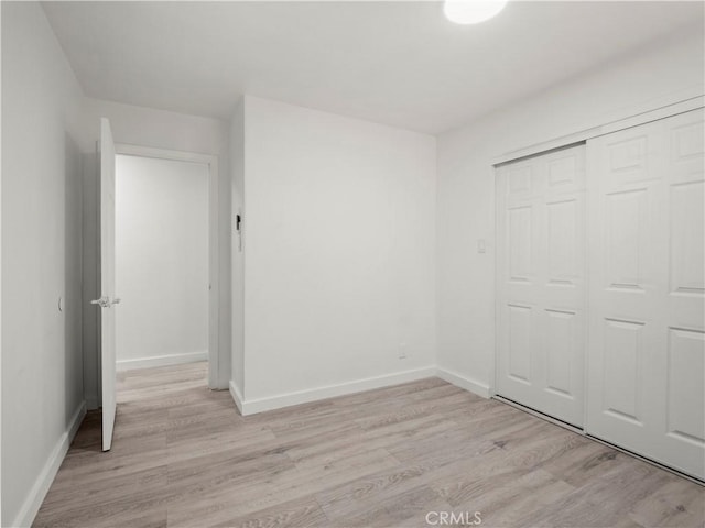 38809 Juniper Tree Rd, Palmdale, CA 93551 - unfurnished bedroom featuring light wood-style floors, baseboards, and a closet