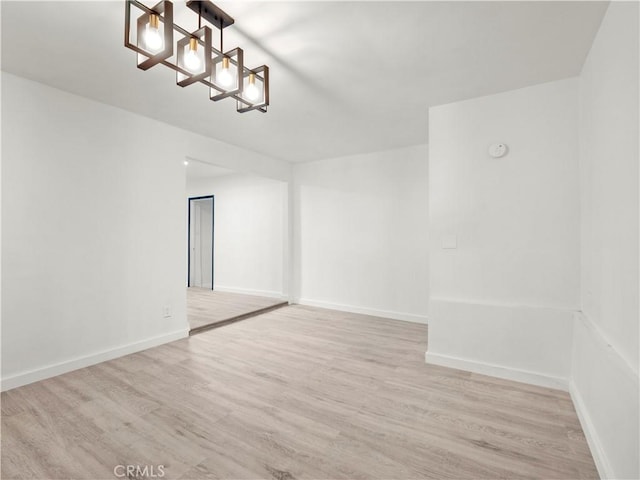 38809 Juniper Tree Rd, Palmdale, CA 93551 - empty room with a chandelier, wood finished floors, and baseboards