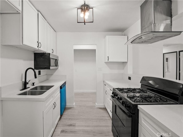 38809 Juniper Tree Rd, Palmdale, CA 93551 - kitchen featuring black gas range, island range hood, a sink, stainless steel microwave, and light wood-style flooring