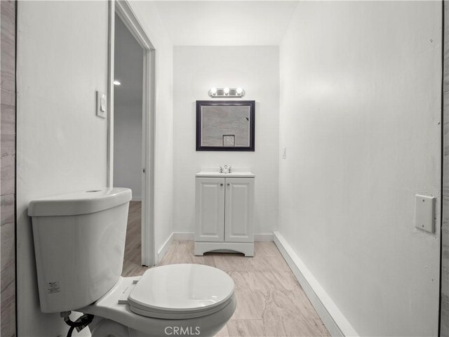 38809 Juniper Tree Rd, Palmdale, CA 93551 - bathroom featuring toilet, vanity, and baseboards