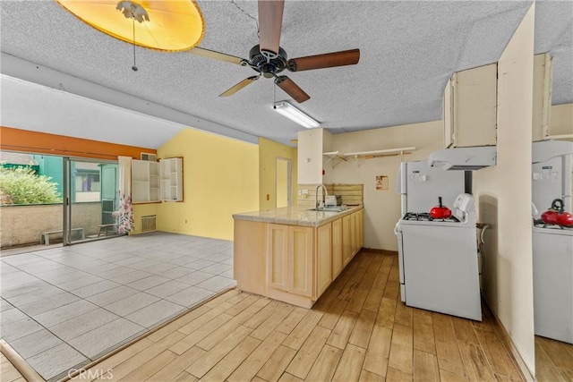 15321 Santa Gertrudes Ave Unit J210, La Mirada, CA 90638 - kitchen featuring white appliances, exhaust hood, light wood-style flooring, open floor plan, and a textured ceiling