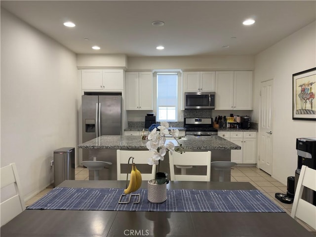 22111 Main St Unit 6, Carson, CA 90745 - kitchen featuring appliances with stainless steel finishes, white cabinetry, a kitchen island, and recessed lighting