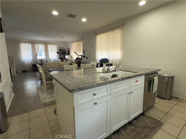 22111 Main St Unit 6, Carson, CA 90745 - kitchen featuring dishwasher, a kitchen island with sink, white cabinetry, light stone counters, and open floor plan