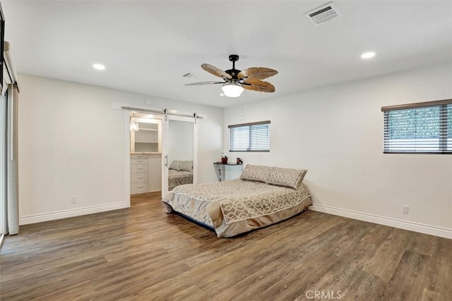 12081 Martha Ann Dr, Los Alamitos, CA 90720 - bedroom with a barn door, wood finished floors, baseboards, recessed lighting, and ceiling fan