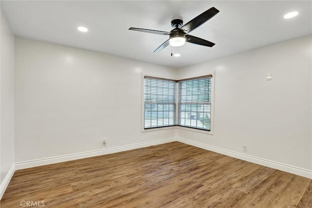 12081 Martha Ann Dr, Los Alamitos, CA 90720 - spare room with wood finished floors, ceiling fan, baseboards, and recessed lighting