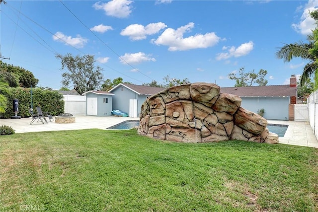 12081 Martha Ann Dr, Los Alamitos, CA 90720 - view of yard with an outdoor fire pit, a patio area, and an outdoor structure