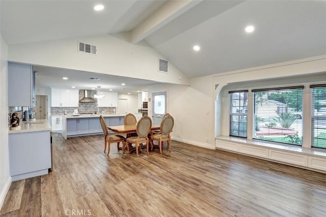 12081 Martha Ann Dr, Los Alamitos, CA 90720 - dining room with beam ceiling, high vaulted ceiling, wood finished floors, baseboards, and recessed lighting