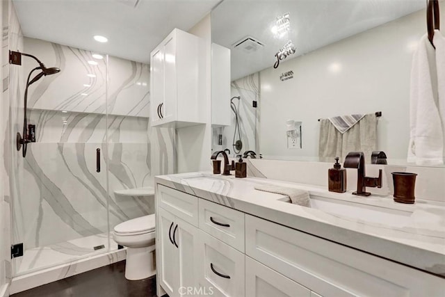 12081 Martha Ann Dr, Los Alamitos, CA 90720 - bathroom featuring a marble finish shower, toilet, double vanity, and recessed lighting