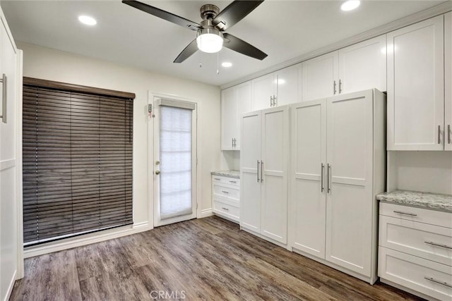 12081 Martha Ann Dr, Los Alamitos, CA 90720 - kitchen with ceiling fan, white cabinets, recessed lighting, dark wood finished floors, and baseboards