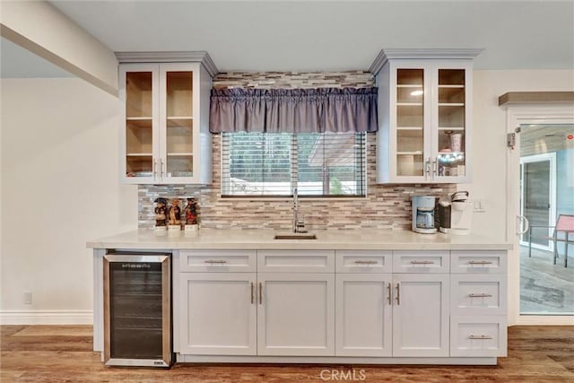 12081 Martha Ann Dr, Los Alamitos, CA 90720 - indoor bar featuring wine cooler, light wood finished floors, backsplash, and baseboards