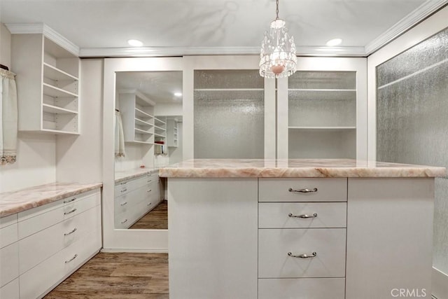 12081 Martha Ann Dr, Los Alamitos, CA 90720 - walk in closet with wood finished floors and a chandelier