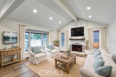 12081 Martha Ann Dr, Los Alamitos, CA 90720 - living room featuring a fireplace, wood finished floors, and recessed lighting