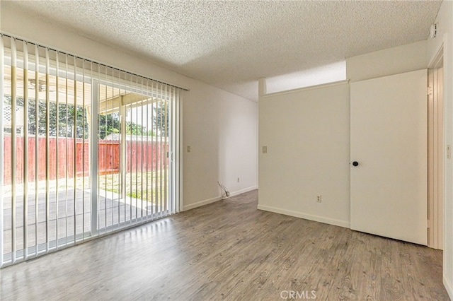 5712 Tupelo Dr, Sacramento, CA 95842 - unfurnished room featuring wood finished floors, a textured ceiling, and baseboards