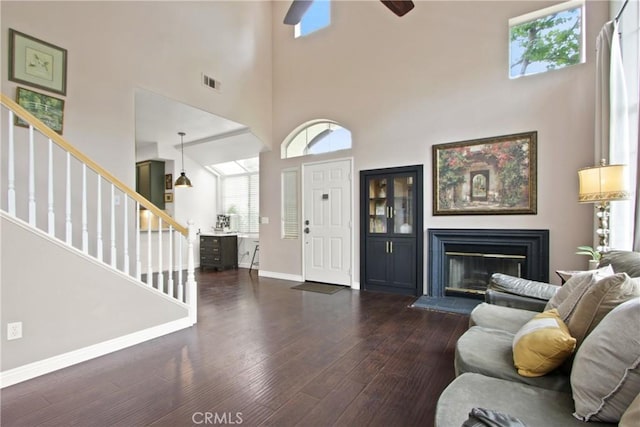19 Tierra Montanosa, Rancho Santa Margarita, CA 92688 - foyer with a towering ceiling, stairs, dark wood-style flooring, a glass covered fireplace, and a ceiling fan