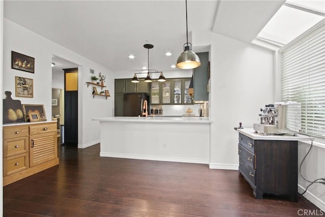 19 Tierra Montanosa, Rancho Santa Margarita, CA 92688 - kitchen with freestanding refrigerator, glass insert cabinets, light countertops, a peninsula, and dark wood-style flooring