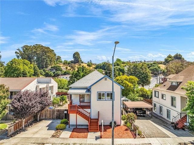 1107 Tennent Ave, Pinole, CA 94564 - view of front of home with concrete driveway, stairs, a residential view, and a detached carport