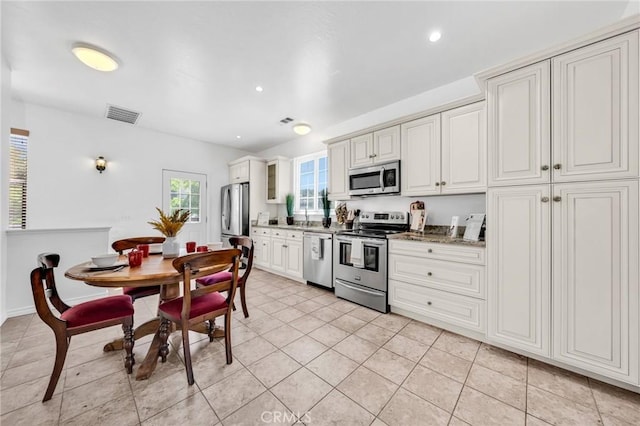 1107 Tennent Ave, Pinole, CA 94564 - kitchen featuring appliances with stainless steel finishes, light tile patterned flooring, recessed lighting, glass insert cabinets, and white cabinets