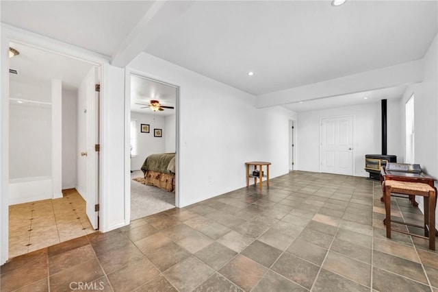 1107 Tennent Ave, Pinole, CA 94564 - unfurnished living room featuring a wood stove, ceiling fan, recessed lighting, and baseboards