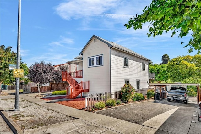 1107 Tennent Ave, Pinole, CA 94564 - view of side of home featuring concrete driveway and stairway