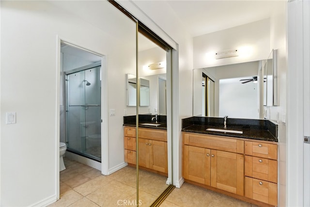 11340 Reseda Blvd, Porter Ranch, CA 91326 - full bathroom featuring a stall shower, a ceiling fan, two vanities, tile patterned flooring, and toilet