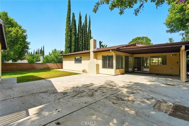 11340 Reseda Blvd, Porter Ranch, CA 91326 - back of property featuring stucco siding, a chimney, and a patio area