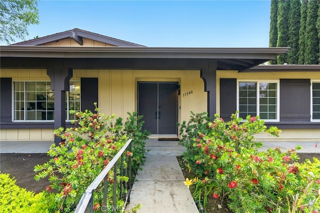 11340 Reseda Blvd, Porter Ranch, CA 91326 - doorway to property with a porch and board and batten siding