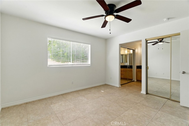 11340 Reseda Blvd, Porter Ranch, CA 91326 - unfurnished bedroom with ensuite bath, baseboards, ceiling fan, and light tile patterned floors