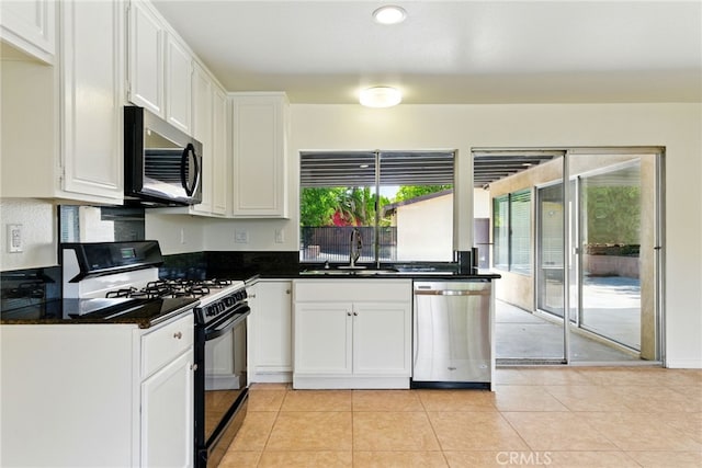 11340 Reseda Blvd, Porter Ranch, CA 91326 - kitchen featuring stainless steel appliances, a sink, dark countertops, white cabinets, and light tile patterned floors